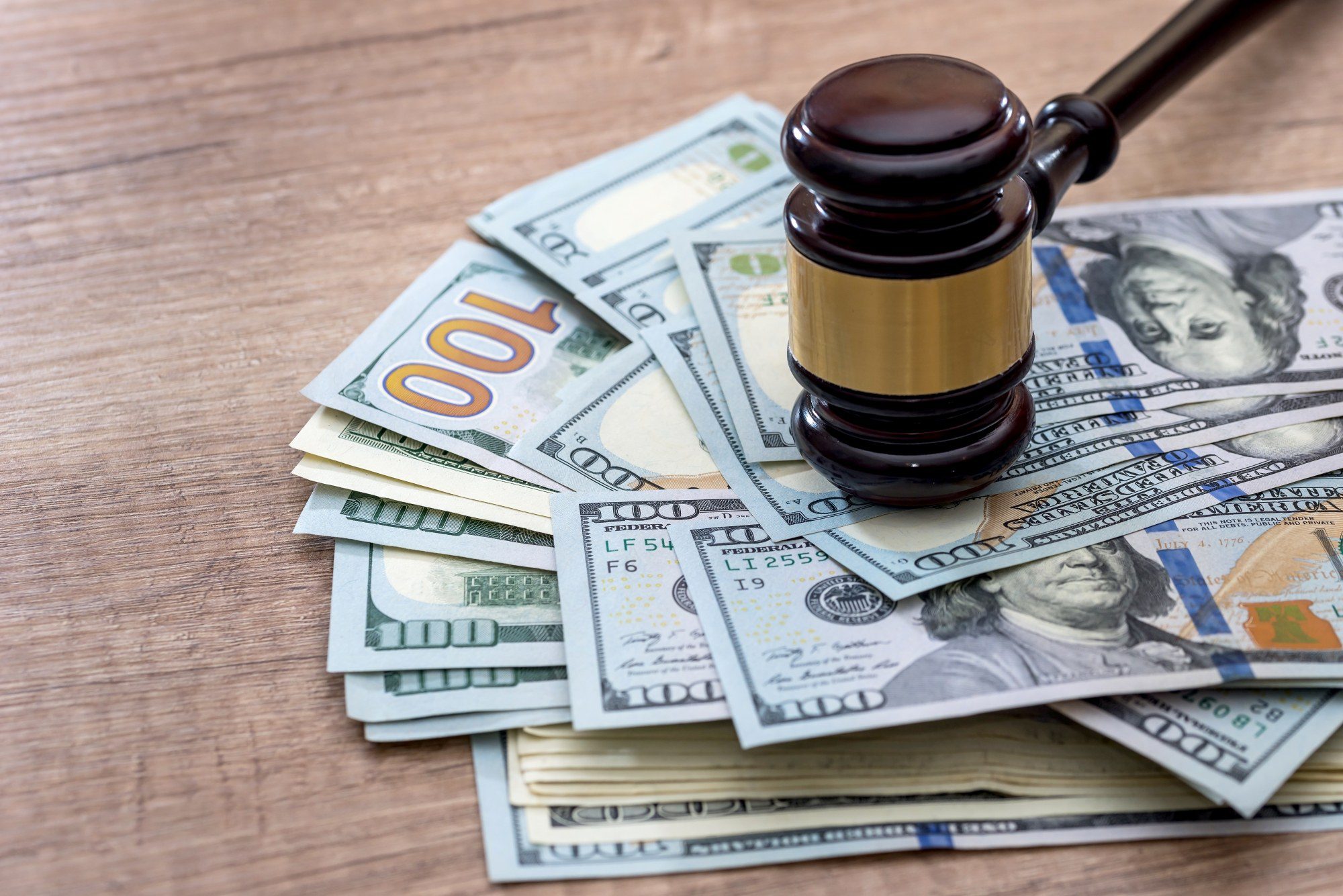 A gavel on top of a pile of money.