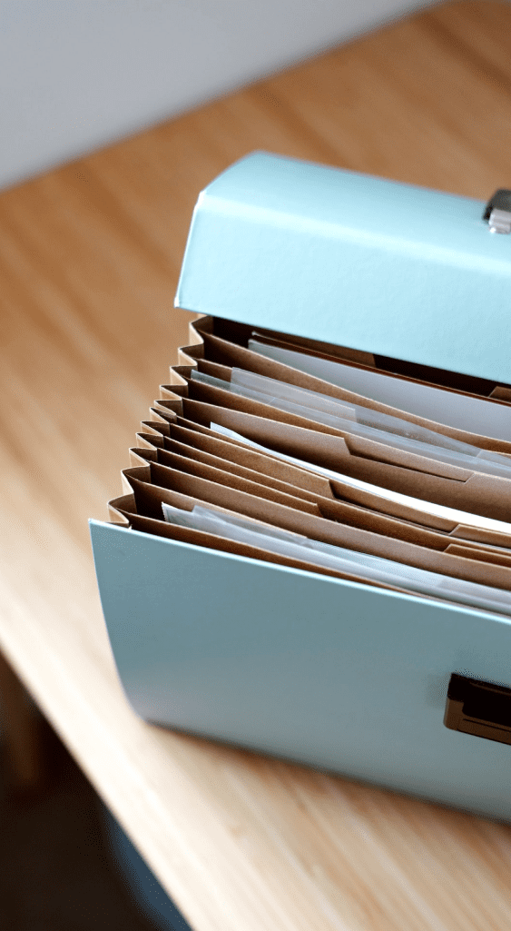 A blue file folder sitting on a wooden table, highlighting Girard Bengali's case win.