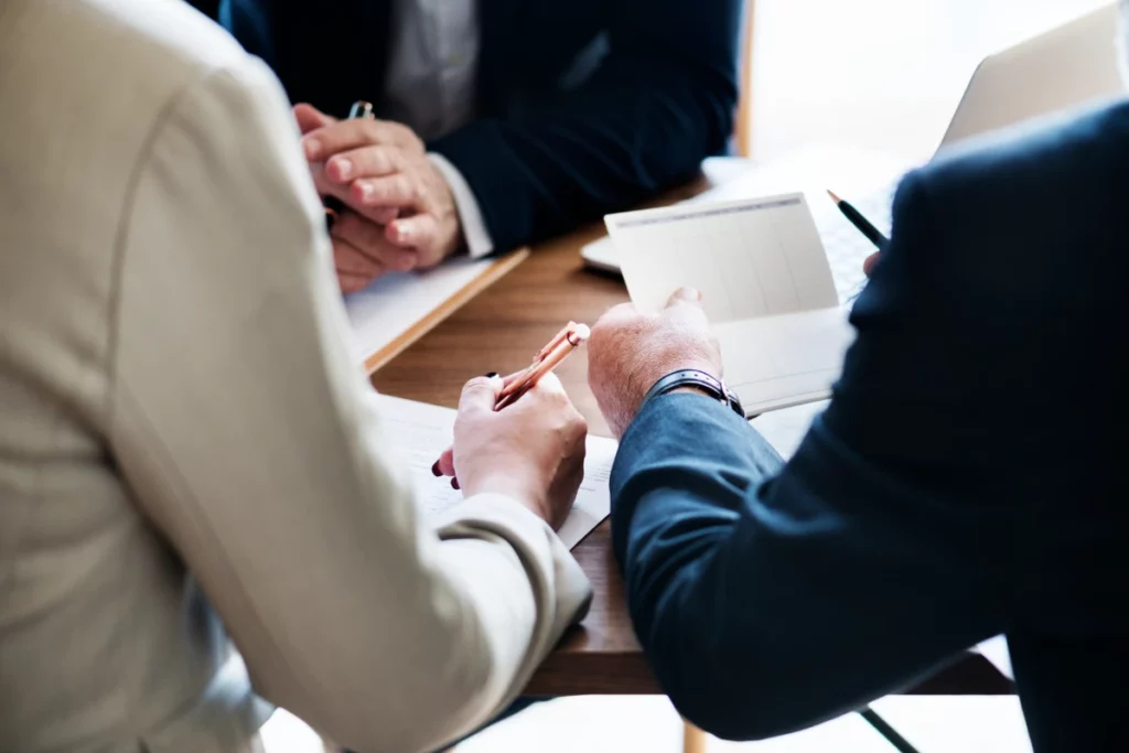 A group of business people sitting around a table.