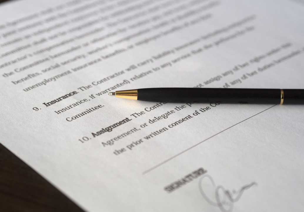 A pen sits on top of a document.