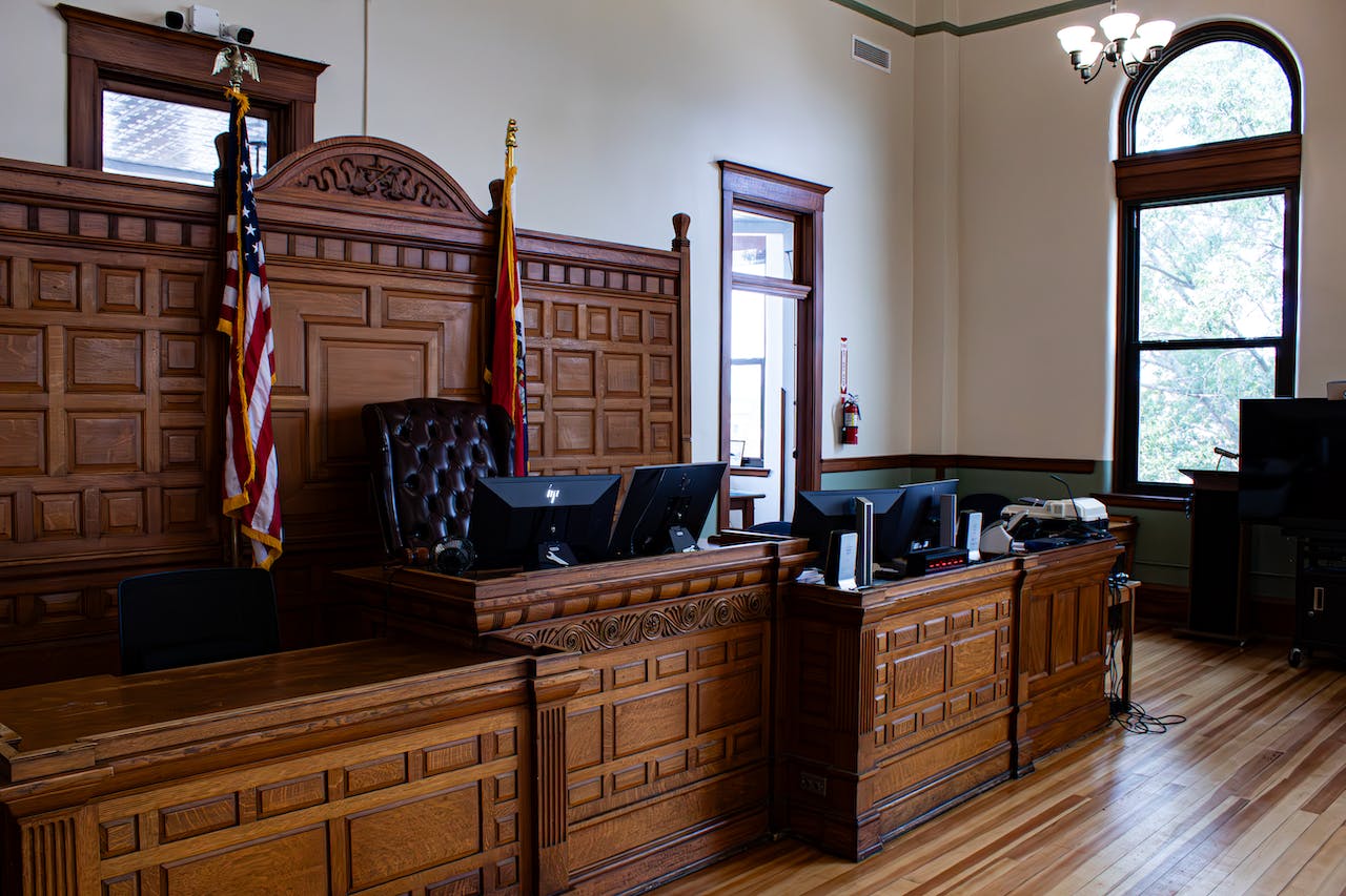 A wooden bench in a courtroom.